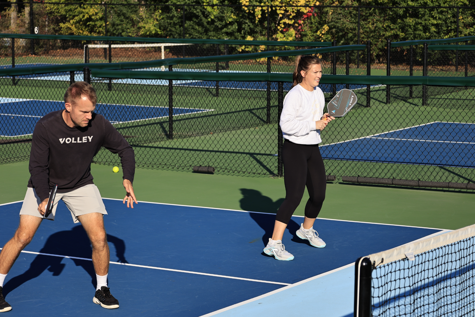 Two members playing pickleball, each with their Volley Assessment Index rating