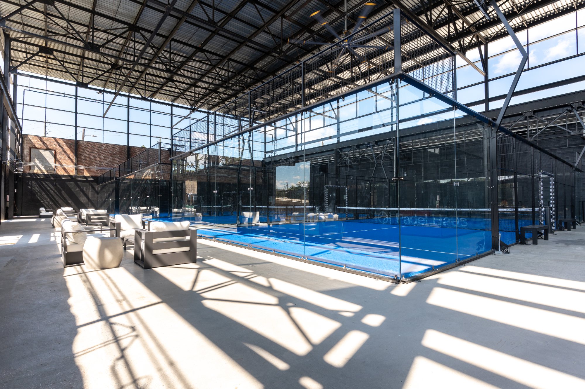 The premium glass-walled padel courts at Padel Haus