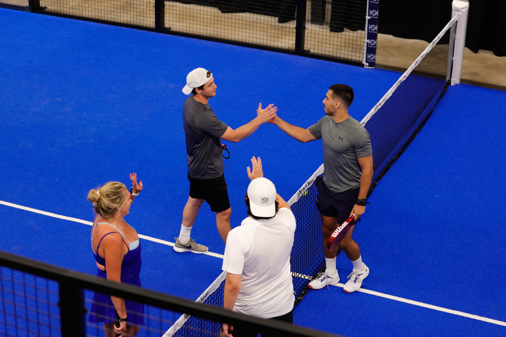 Padel Haus members shaking hands at the net after a match